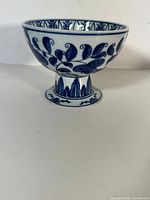 Side view of footed blue-and-white ceramic cup washer