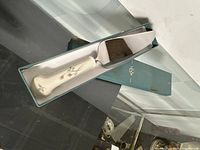 Cake server in open Lenox box showing entire piece