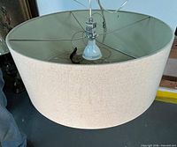 full view of drum chandelier showing shade and interior bulb socket