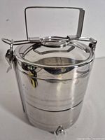 Full view of stacked stainless steel tiffin showing two tiers and lid