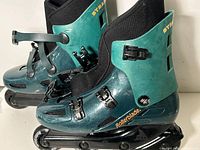 side view of both skates showing color, model name and buckles