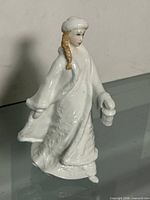 Front left view of Royal Doulton white porcelain lady figurine holding lantern