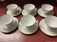 Overhead view of six teacup and saucer pairs