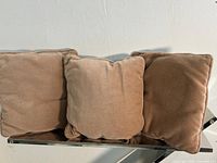 Three tan cushions on bench showing overall appearance