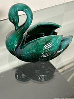 Full view of glazed ceramic swan planter