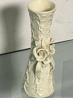 Full view of porcelain vase showing overall shape and floral relief