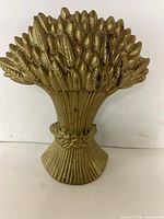 Front view of cast iron wheat sheaf door stopper