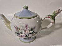 Right side view showing floral design and spout