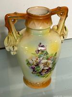 Front view of vase showing floral design and handles
