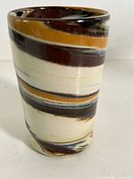 Front view of stoneware tumbler showing swirl pattern