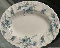 Top view of oval platter showing blue floral pattern and scalloped edge