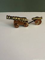 Both brass miniature cannons assembled, showing size and patina
