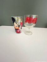 Front view of Mickey Mouse tumbler and Pepsi-Cola goblet