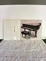 Both Elton John LP covers side by side