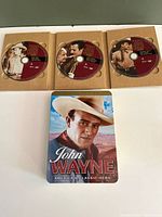 Front view showing three discs in cardboard sleeves and tin cover art