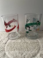 Front view of both glasses showing red and green Fuwa graphics