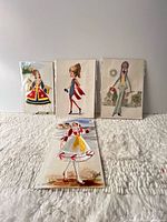 Group shot of all four postcards front view