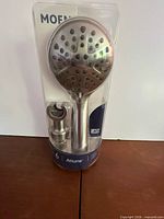 Front view of Moen Attune handheld showerhead in packaging
