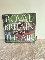 Front cover of Royal Britain From The Air book with penknife beside
