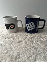 Front view of both team mugs