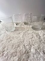 Group shot of all four tumblers showing shapes and embossing