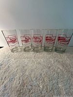 Front view of all five tumblers showing red TTC graphics