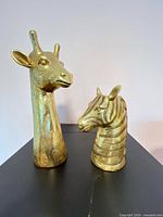 Front view of both giraffe and zebra busts