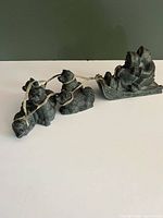 Full view of sled and four dogs linked by straps