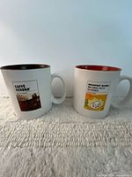Front view showing both mugs’ exterior graphics