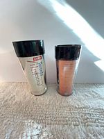 Front views of both tumblers: Film Festival text graphic and reverse text panel of portrait tumbler