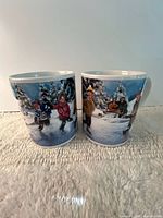 Front view showing winter skating scene on both mugs