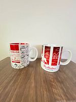 Front view of both Tim Hortons mugs showing graphics and handles