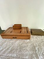 Top view of wood organizer beside closed brass box