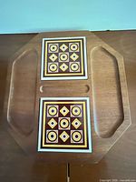 Top view of wood tray showing tile insets and handle cutouts