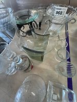 Group shot of assorted glassware plus metal stands on table