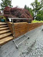 Full view of garment rack showing chrome frame and casters