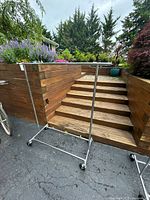 Full view of chrome garment rack showing width, base, casters