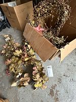 Wreath, metal star and garland inside and outside box