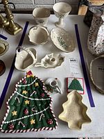 Lot overview showing Lenox holly porcelain pieces, ceramic and metal tree dishes, brass candlesticks and accessories