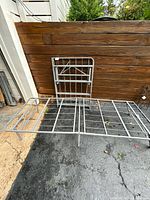 Frame partially unfolded showing grid platform and legs
