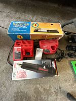 Group shot of both chargers, Precision Hot Tool box and tile cutter box