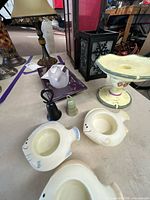 Overview showing fish planters, bells, purple tray, frosted glass votive, pedestal dish, tall lantern and black lantern