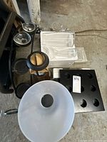 Group view showing frosted shade, black metal candle stand, tealight cups, clear vases, square tealight tray