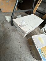 Boxed HALO recessed lighting kit alongside loose glass shades