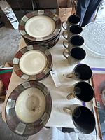 Plates and mugs laid out on table