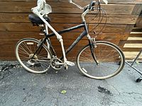 Full left side view of Univega Via Montega bicycle with 700c wheels and black frame