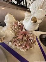 Full view of figurine showing both birds and rose cluster with gold accents