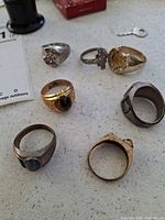 Group of seven assorted rings on tabletop