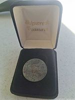 Coin displayed in open Shipwreck Treasures box
