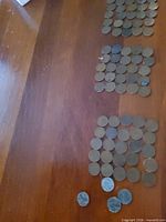 Stacks of assorted wheat pennies on wood surface